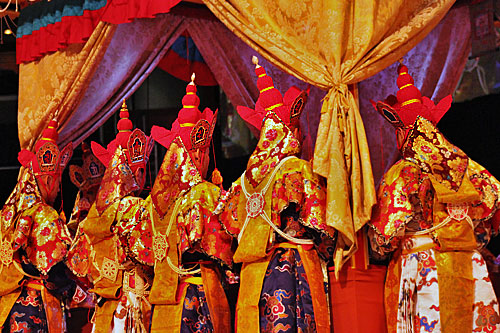 03-Earth-Ritual-Dance3 Elaborate robes and headgear of mnks praying at mandala platform