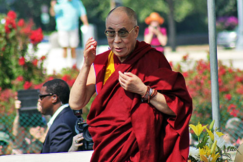 04-Dalai-Lama-Speech1 Dalai Lama on stage at the Capitol lawn; photographers and security in the background