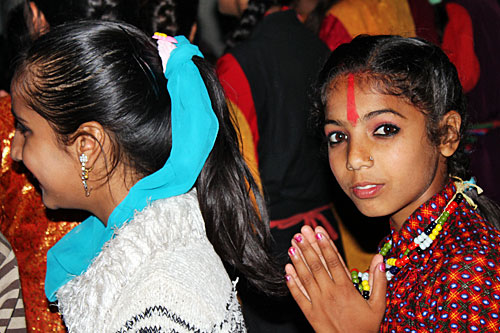Pokhara-Tihar-Street-Dancer2 Nepali girl with red tika on her forehead enjoys Bhailo dancers in the streets of Pokhara on day three of the Tihar festival